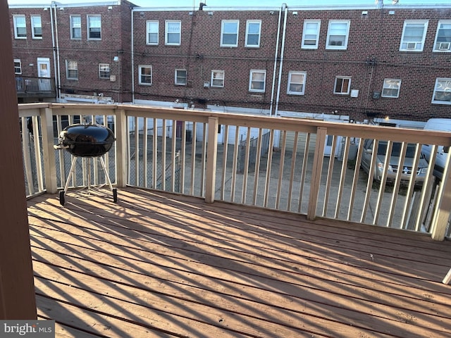 wooden deck with a grill