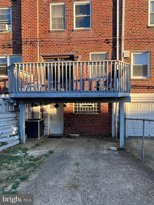 back of house with cooling unit and a deck