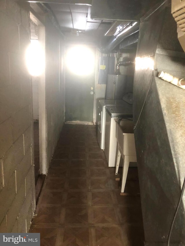 basement featuring washer and dryer and dark parquet flooring