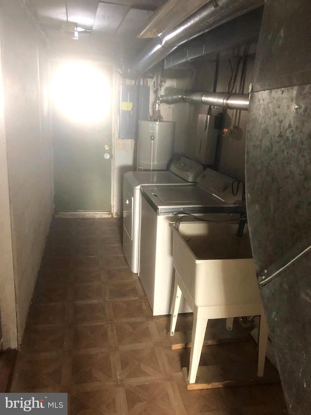 laundry room featuring separate washer and dryer, water heater, and dark parquet floors