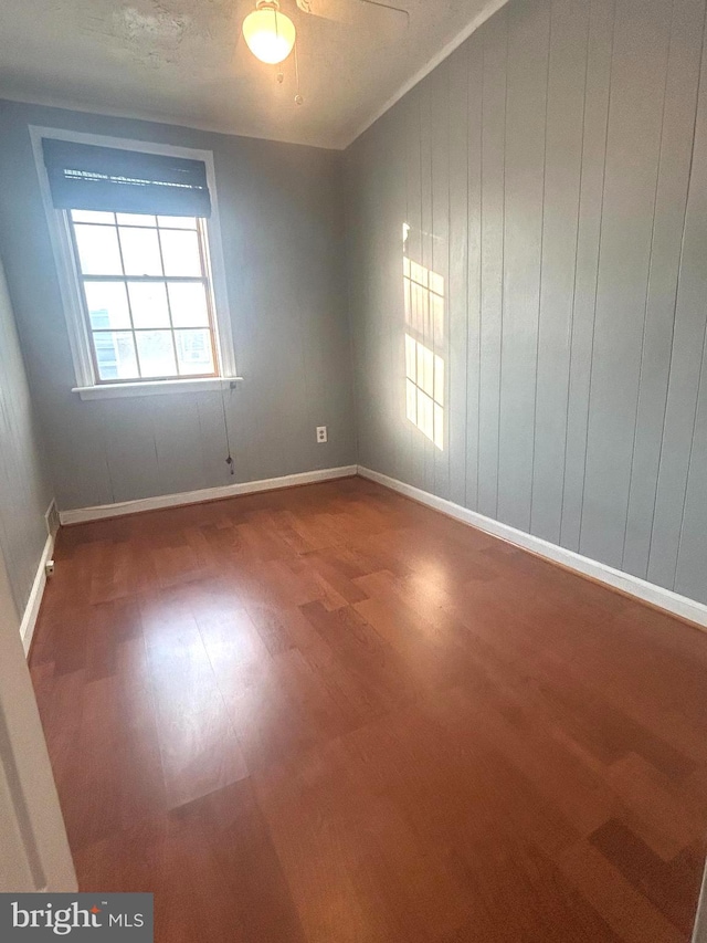 empty room with wood-type flooring and ceiling fan