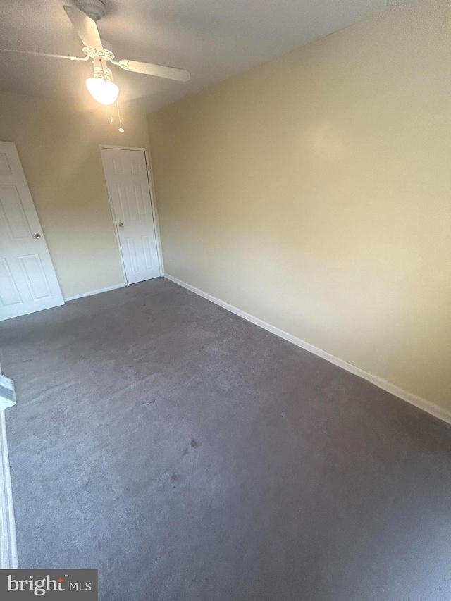 carpeted spare room with ceiling fan