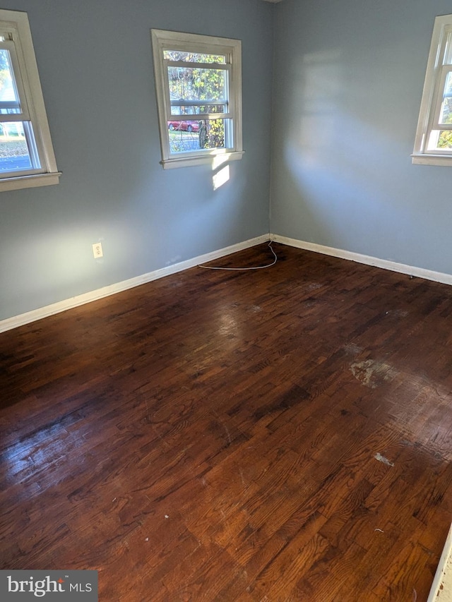 spare room featuring dark wood-type flooring