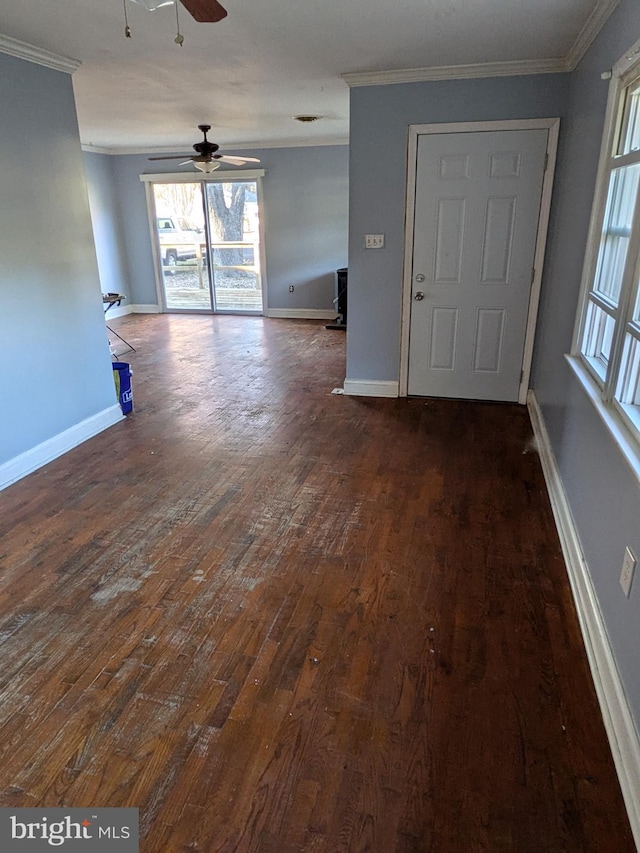 empty room featuring dark hardwood / wood-style floors, ceiling fan, and crown molding