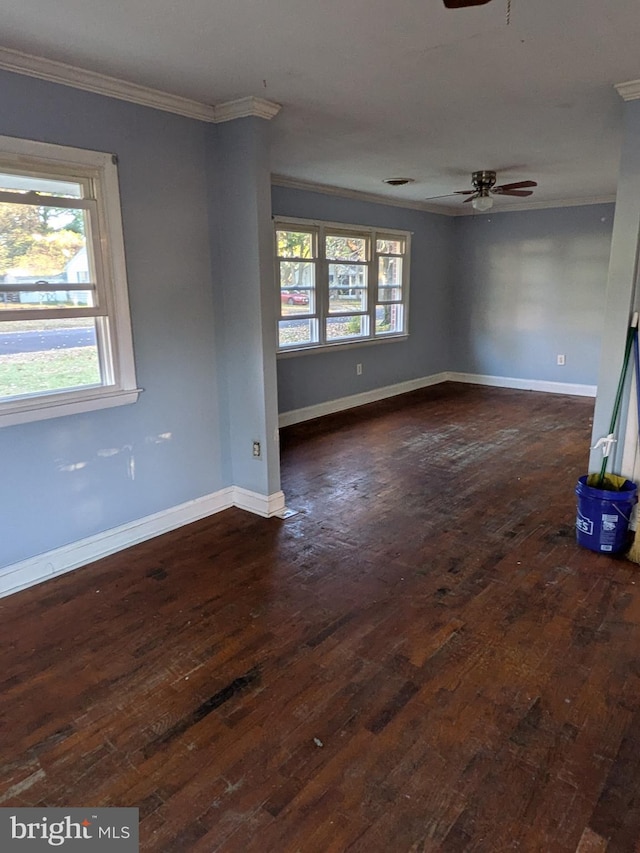 unfurnished room featuring dark hardwood / wood-style flooring, a wealth of natural light, and ornamental molding