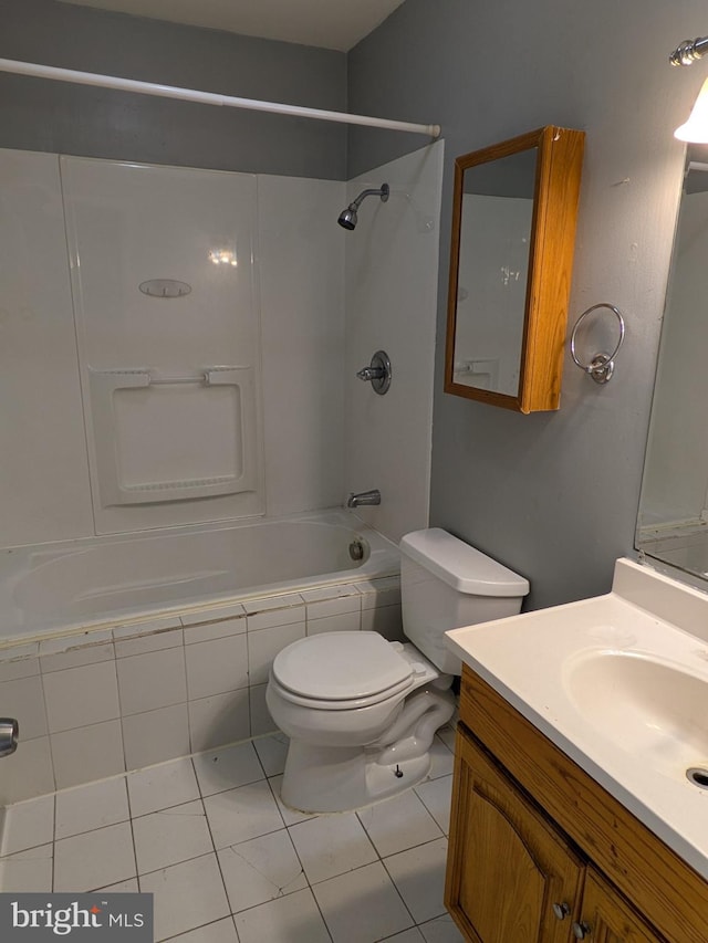 full bathroom with toilet, vanity, tile patterned floors, and tiled shower / bath