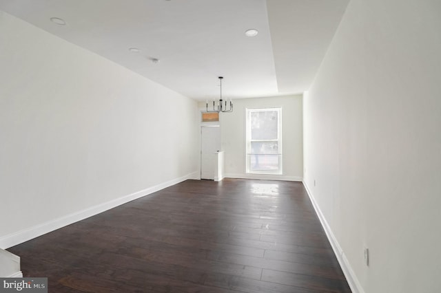 interior space featuring dark hardwood / wood-style floors and a notable chandelier