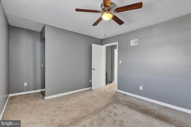 unfurnished bedroom with ceiling fan and light carpet