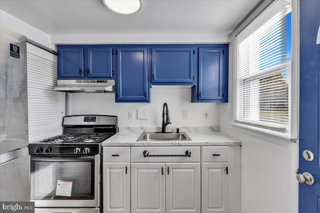 kitchen with blue cabinetry, stainless steel appliances, sink, and white cabinets