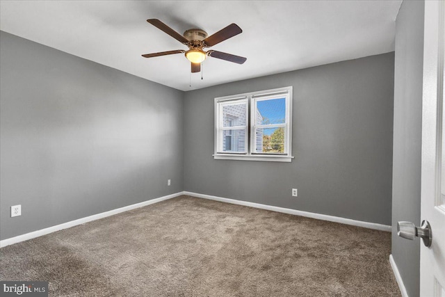 empty room featuring ceiling fan and carpet