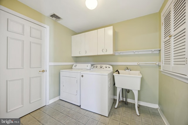 laundry area with washer and dryer and cabinets