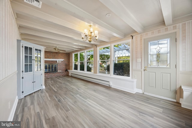 interior space with a baseboard heating unit, beam ceiling, hardwood / wood-style floors, and a fireplace