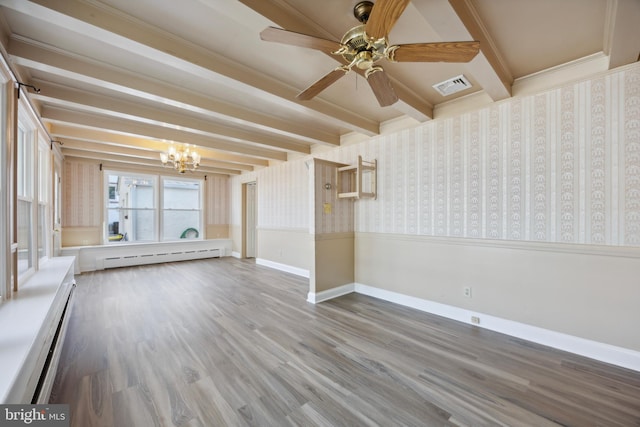 empty room with ceiling fan with notable chandelier, beamed ceiling, wood-type flooring, and a baseboard radiator