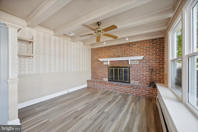 unfurnished living room featuring a fireplace, dark hardwood / wood-style flooring, beamed ceiling, baseboard heating, and crown molding