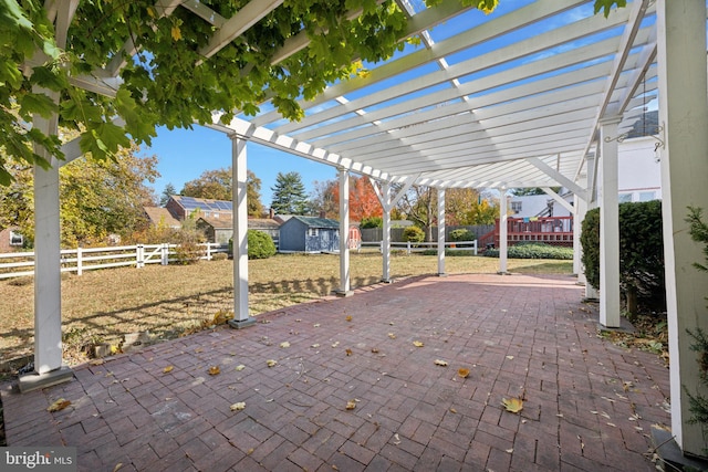 view of patio / terrace featuring a pergola and a shed