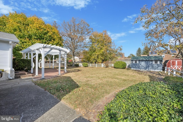 view of yard featuring a storage unit, a patio, and a pergola