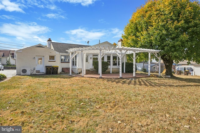 back of property with ac unit, a yard, a patio, and a pergola