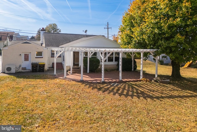 rear view of house with a pergola, a patio area, a yard, and ac unit