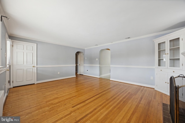 unfurnished room with ornamental molding and light hardwood / wood-style flooring