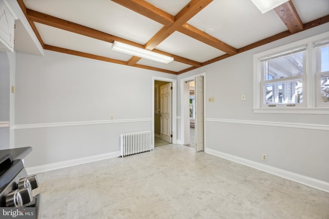 spare room featuring beam ceiling and radiator heating unit