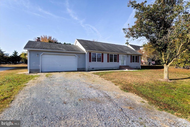 ranch-style house with a garage and a front lawn