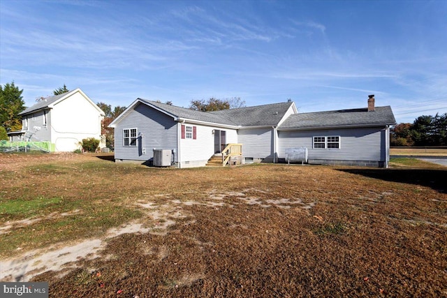 back of house with central air condition unit