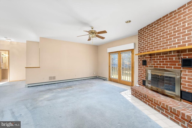 unfurnished living room featuring a baseboard radiator, ceiling fan, a fireplace, french doors, and light colored carpet