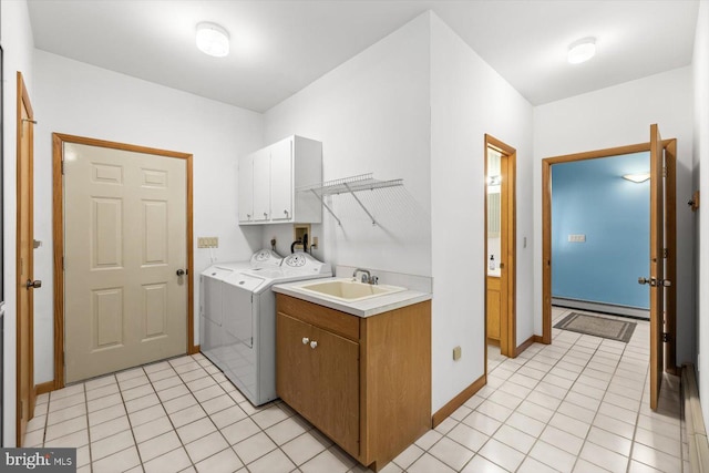 washroom with a baseboard radiator, separate washer and dryer, sink, cabinets, and light tile patterned floors