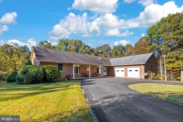 single story home featuring a front yard and a garage