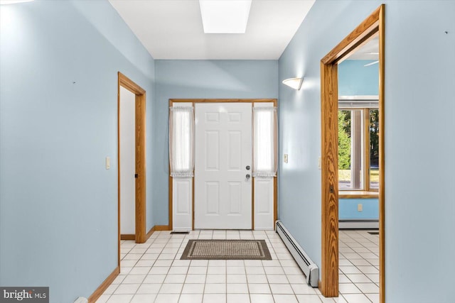 foyer entrance featuring a baseboard heating unit and light tile patterned floors