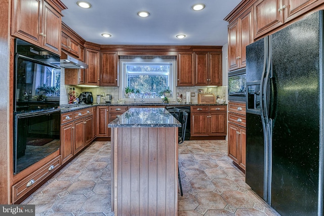 kitchen with backsplash, dark stone counters, ventilation hood, black appliances, and a center island