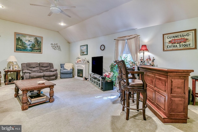 living room with lofted ceiling, carpet, bar, and ceiling fan