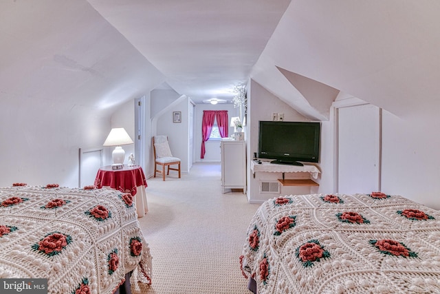 bedroom with light carpet and lofted ceiling