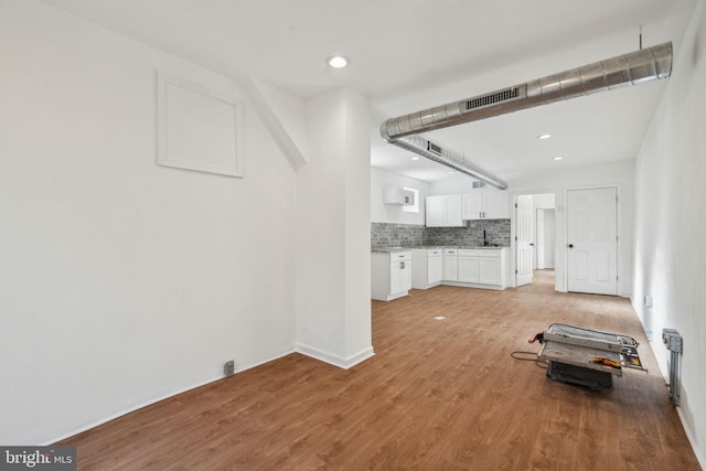 unfurnished living room with light hardwood / wood-style flooring