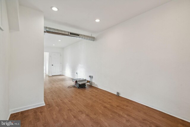 laundry room with wood-type flooring