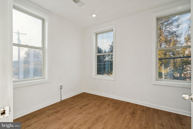 empty room with hardwood / wood-style flooring