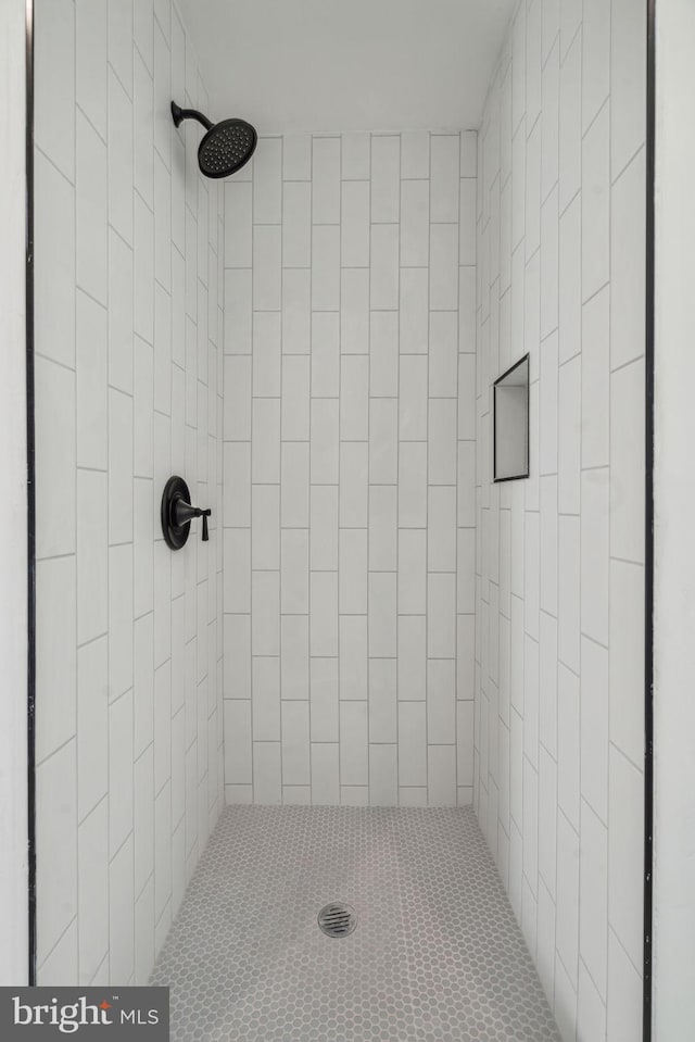 bathroom with a tile shower