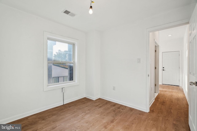 empty room featuring hardwood / wood-style flooring