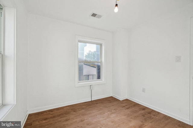 empty room with hardwood / wood-style floors