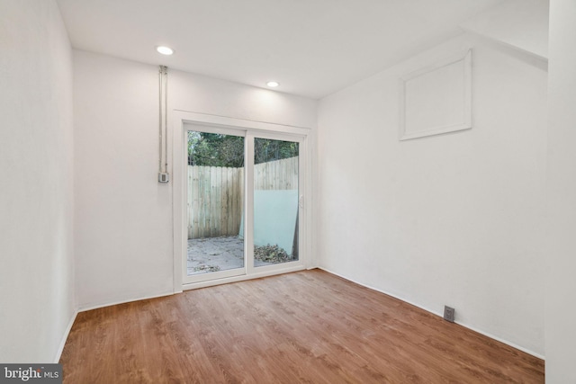 spare room with hardwood / wood-style flooring