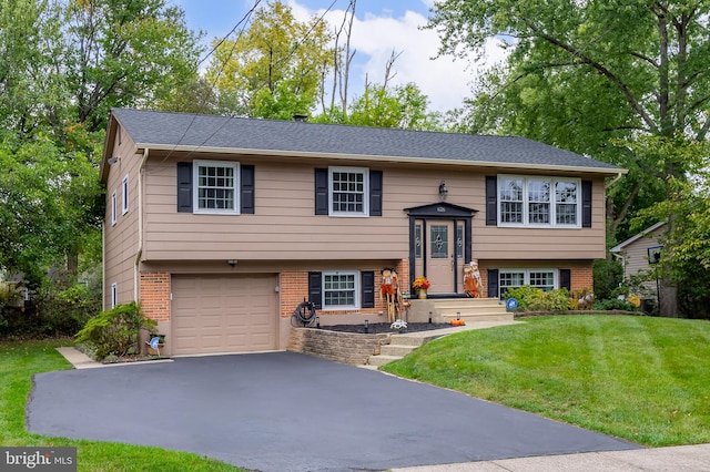 raised ranch featuring a front yard and a garage