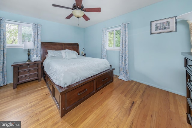 bedroom with light hardwood / wood-style flooring and ceiling fan