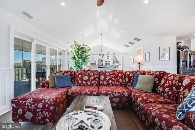 living room featuring lofted ceiling, a notable chandelier, and dark hardwood / wood-style floors