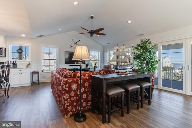 living room with vaulted ceiling, ceiling fan, and dark hardwood / wood-style flooring