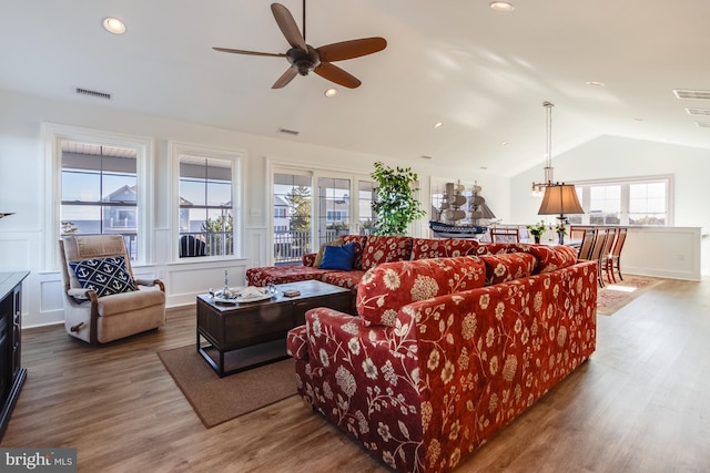 living room featuring lofted ceiling, plenty of natural light, and hardwood / wood-style floors