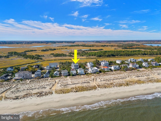 drone / aerial view featuring a water view and a view of the beach