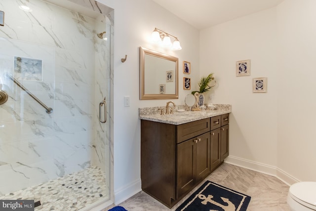 bathroom with vanity, toilet, and a shower with shower door