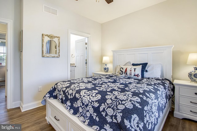 bedroom with dark hardwood / wood-style floors, ensuite bathroom, and ceiling fan