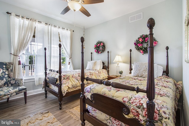 bedroom with hardwood / wood-style floors and ceiling fan