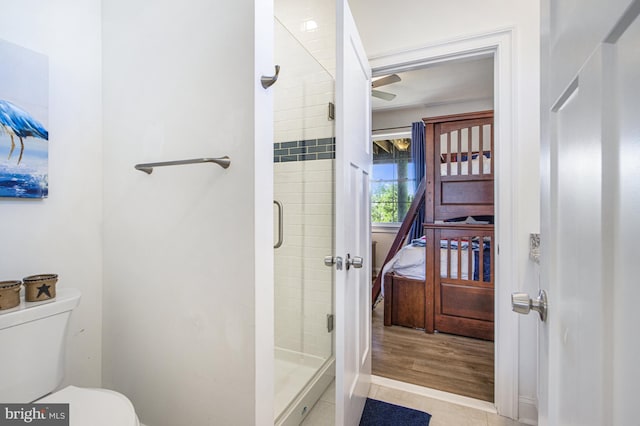 bathroom featuring tile patterned floors, toilet, and walk in shower